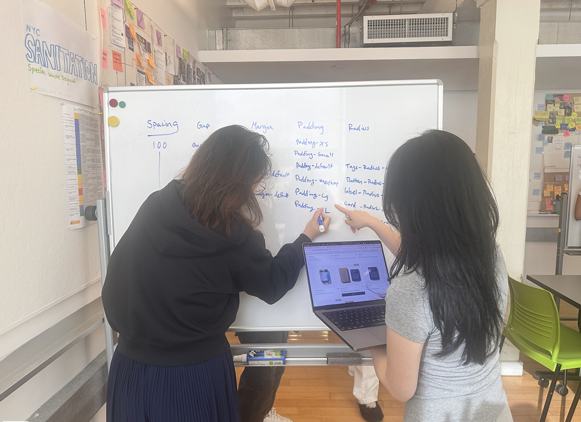 Team working through token structure on a whiteboard